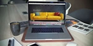 open laptop showing yellow sofa